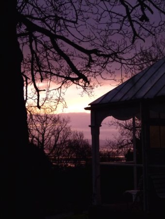 summerhouse silhouetted against a dawn sky